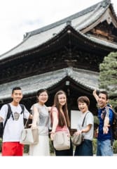 kobe beef tours Group of tourists posing with their local guide at a popular temple in Kyoto