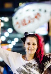 kobe beef tours Tourist posing in front of luminous signs at night on a busy street in Osaka