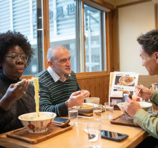 Tourists enjoying Ramen noodles in Japan