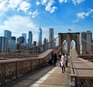 To walk across the Brooklyn Bridge