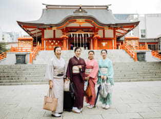 People standing in front of a temple in Tokyo, Japan