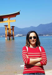 kobe beef tours Tourist standing in front of Itsukushima Floating Torii Gate while on a tour of with a private guide in Hiroshima