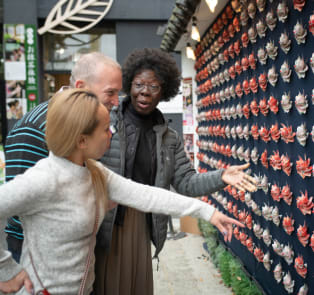 Couple with a local guide observing the wall