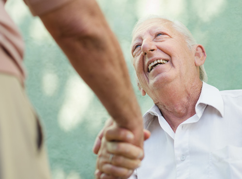caregiver shaking clients hand