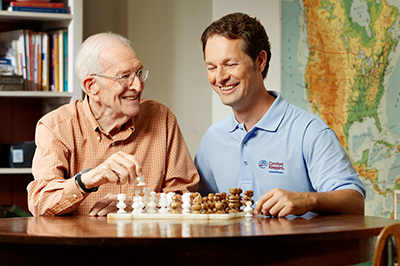 caregiver-playing-chess-with-senior