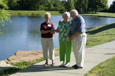 caregiver-with-seniors-on-sidewalk