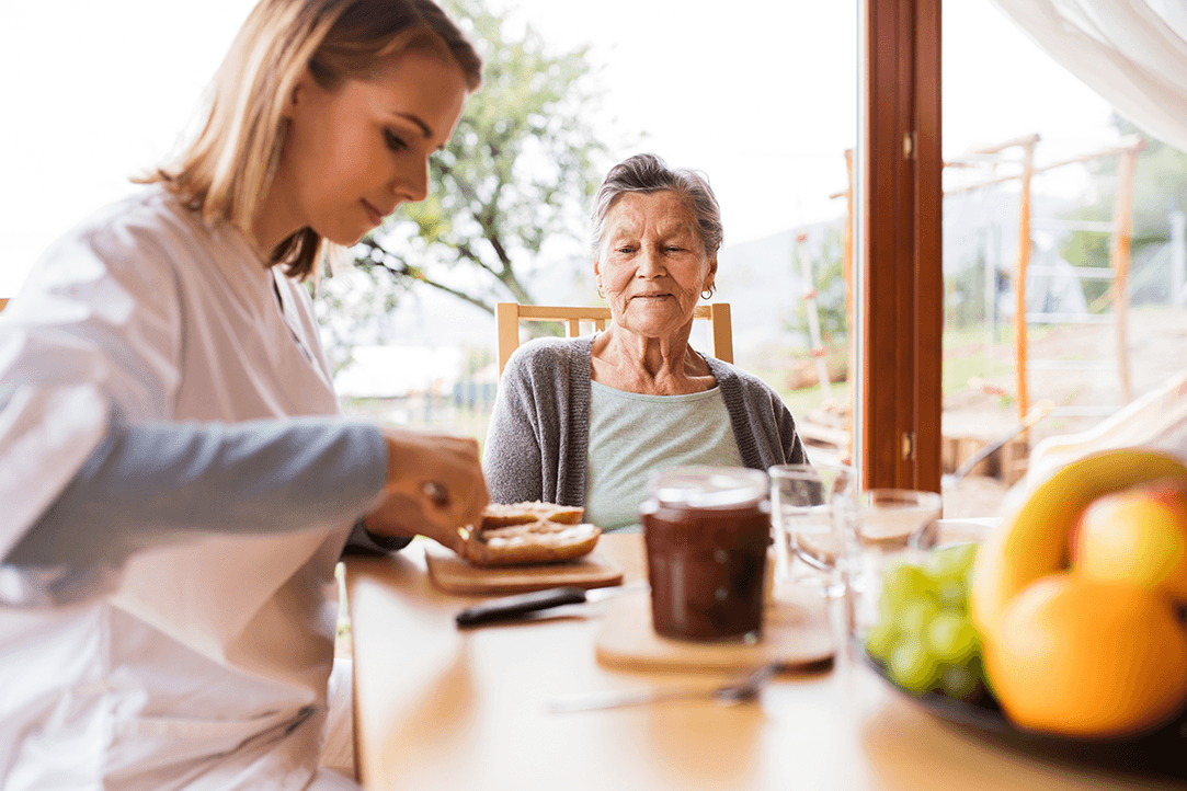 Caregiver and a senior woman during a home visit.