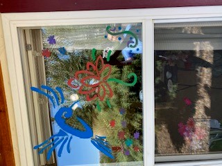 Window with a painting of humming bird on it