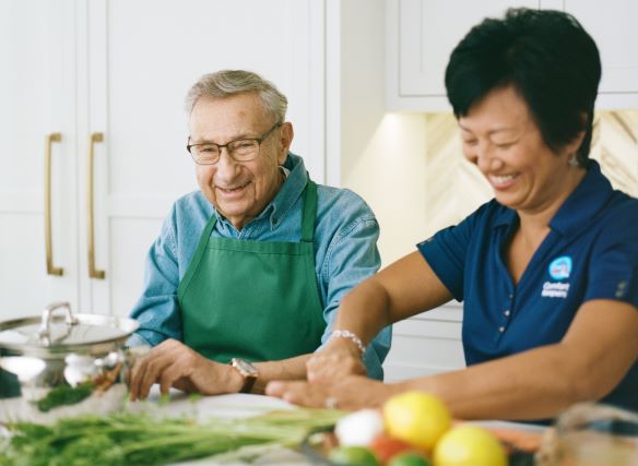 Elderly man getting help cooking as part of his in home care in Owensboro, KY