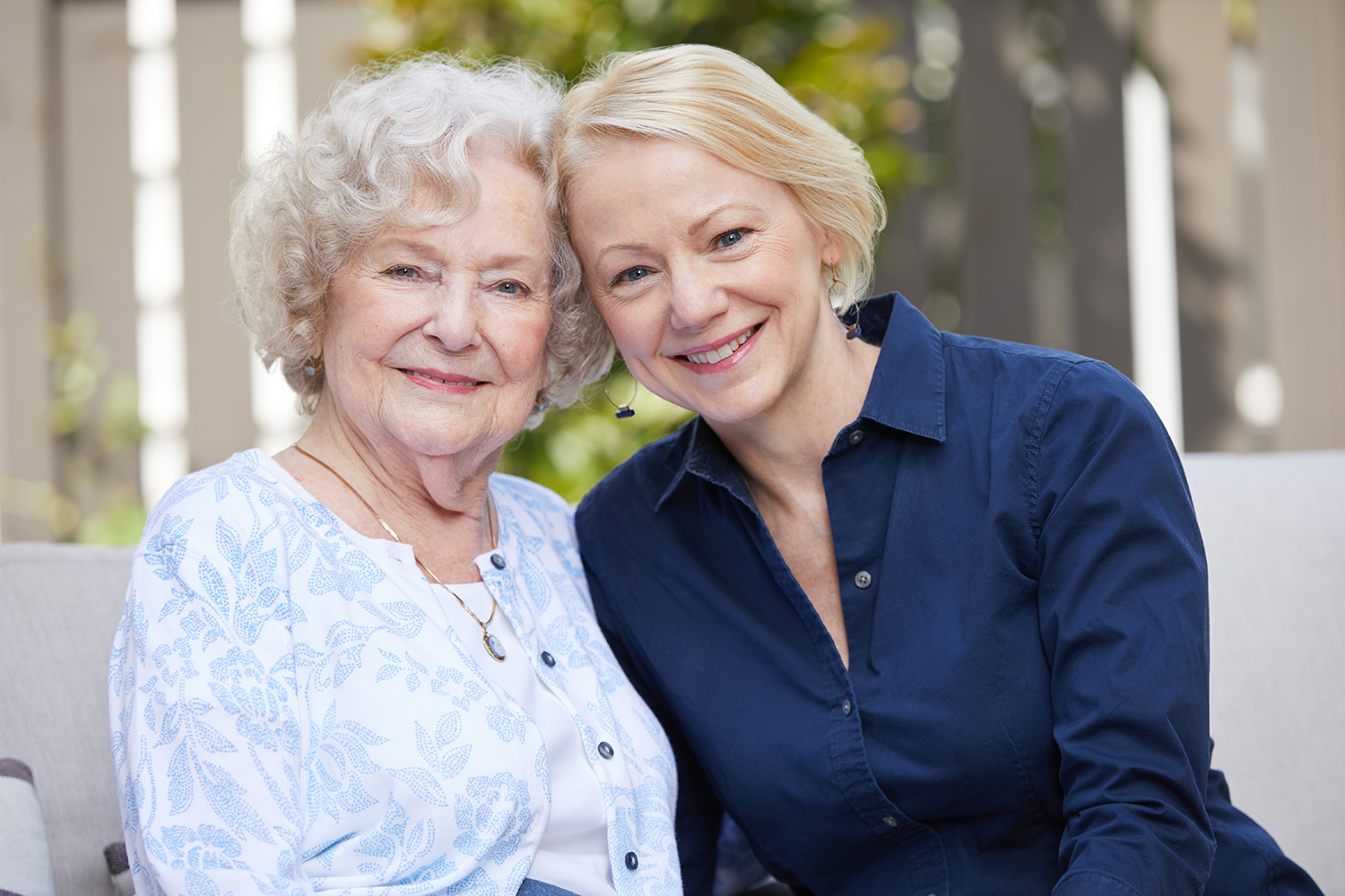 Two women smiling with arms around one another