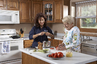 caregiver and senior in Lakeland, Mn kitchen cooking together