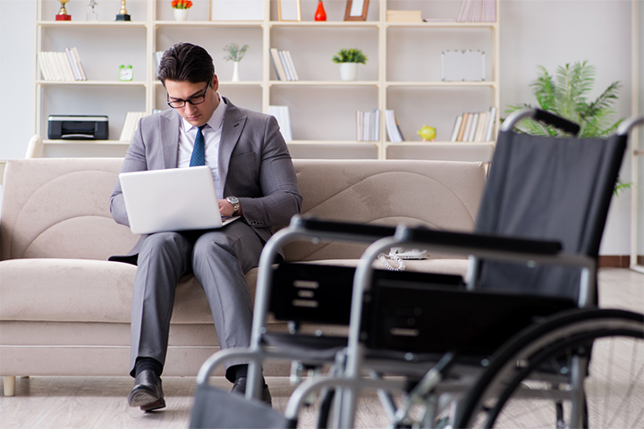 Disabled businessman on wheelchair working home