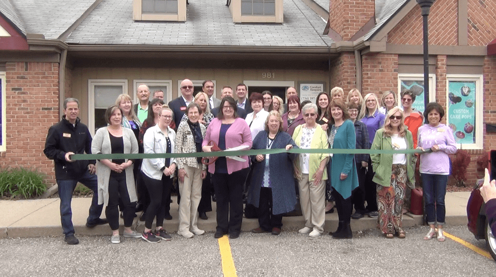 Comfort Keepers Team in Front of Their Office Building Celebrating Their 18th Anniversary