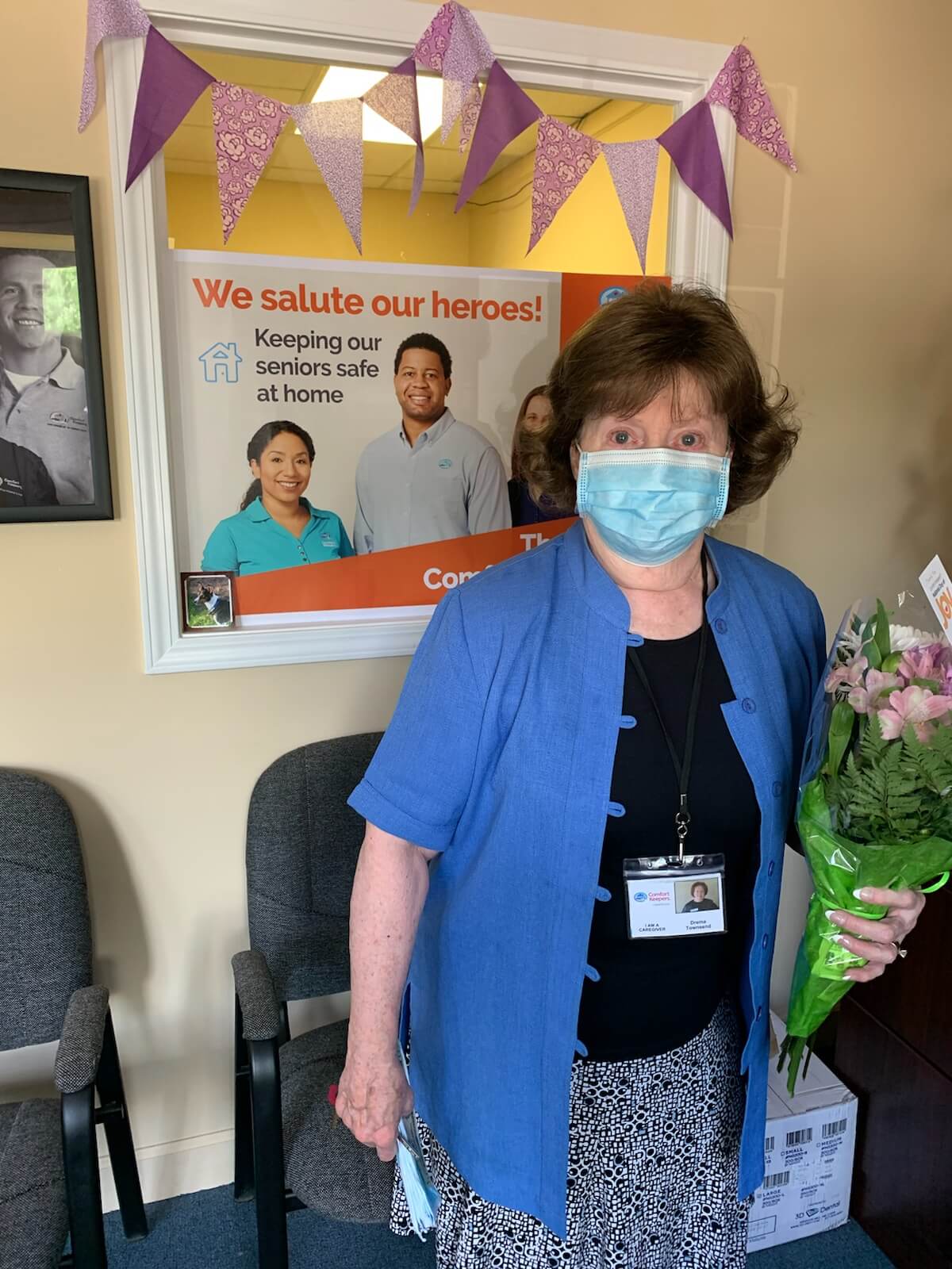 Photo of caregiver wearing a mask in the Comfort Keepers office