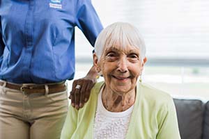 Senior with Alzheimer's and caregiver sitting inside