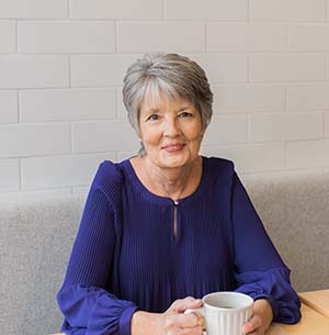 Senior enjoying a cup of coffee at a café near Rancho Mission Viejo