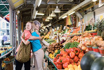 Women with Parkinson's Disease grocery shopping with caregiver