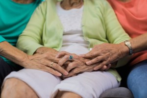 two daughters comforting their mother at home