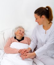 Caregiver comforting senior during end of life care