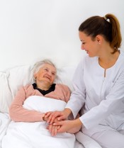 Caregiver comforting senior during end of life care