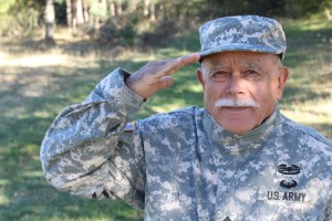 Monterey senior looking at camera and saluting with airborne and air assault insignia on bdu's