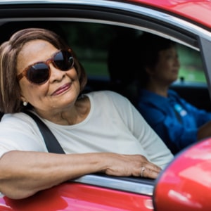 Senior woman enjoying Private transportation services for seniors