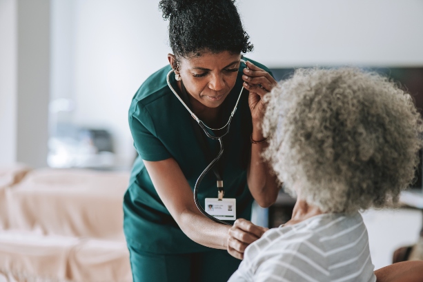 Caretaker checking elderly heartbeat in home care in South Denver, CO