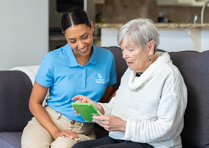 Caregiver walking client down stairs outside