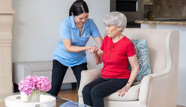 Caregiver walking client down stairs outside