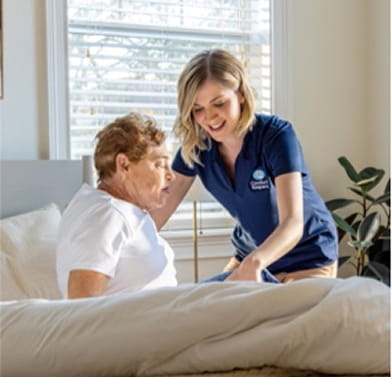 Caregiver walking client down stairs outside