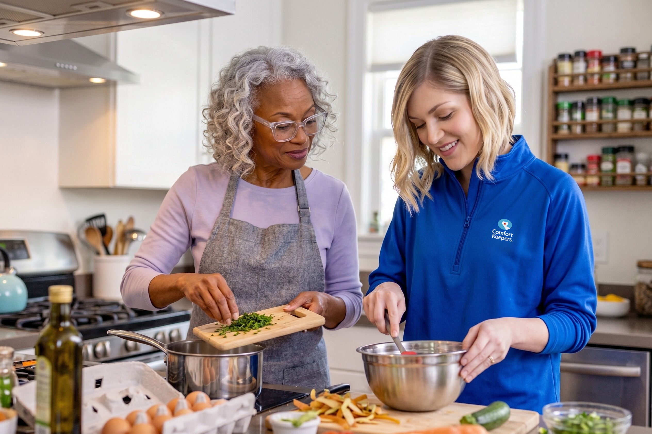 Comfort Keepers caregiver cooking with an older woman in her Gloucester County kitchen