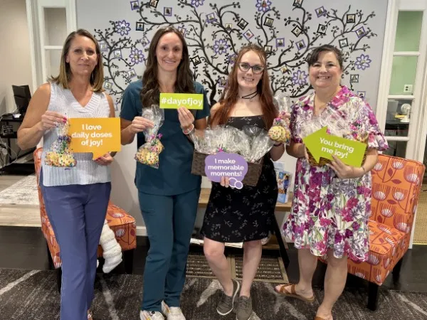 Comfort Keepers Southern Pines staff celebrating National Day of Joy 2025 with group photo and Joy sign