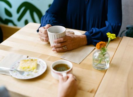 Two people seated at table having coffee