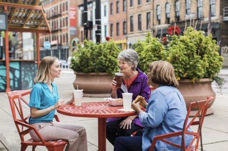 2024 National Day of Joy 3 Women enjoying a drink at table outside