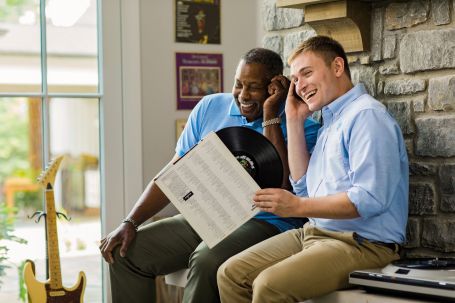 Senior and Caregiver bonding over music.