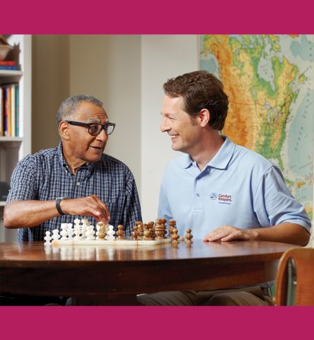 Caregiver playing chess with client