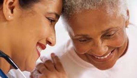 caregiver embracing smiling senior 
