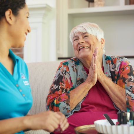 senior residents smiling at a caregiver