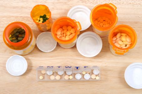 4 prescription bottles with pills in them 