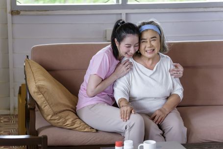 caregiver and elderly on couch