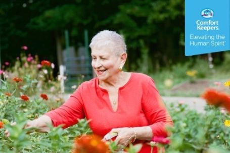 2024 National Day of Joy woman picking flowers in a flower garden