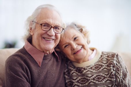 Couple smiling at their primary family caregiver
