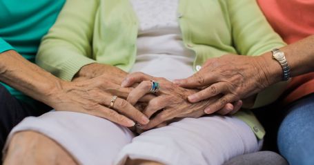 family-holding-hands-of-loved-one