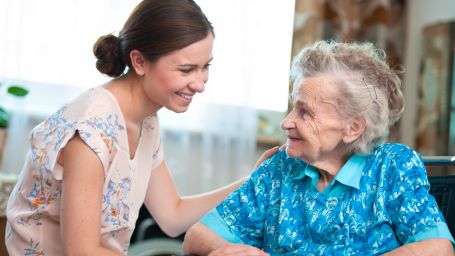 Mom and daughter smiling at each other. 