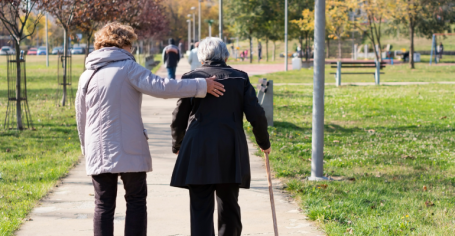 two woman taking a walk in the park 