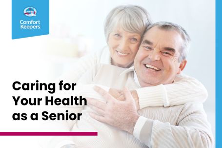 Two older people hugging each other.