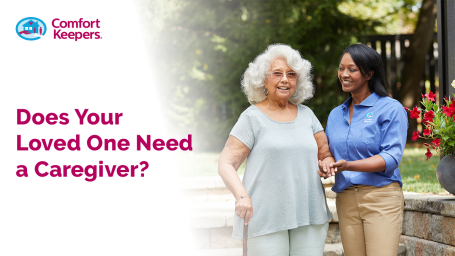 A younger woman supporting an older woman on a walk