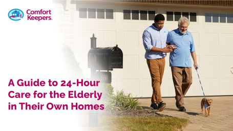 An older man walking his dog with the support of a younger caregiver 