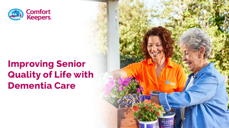 A younger woman supporting an older woman in the garden smiling
