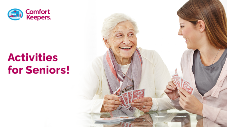An elderly woman and a younger woman playing cards